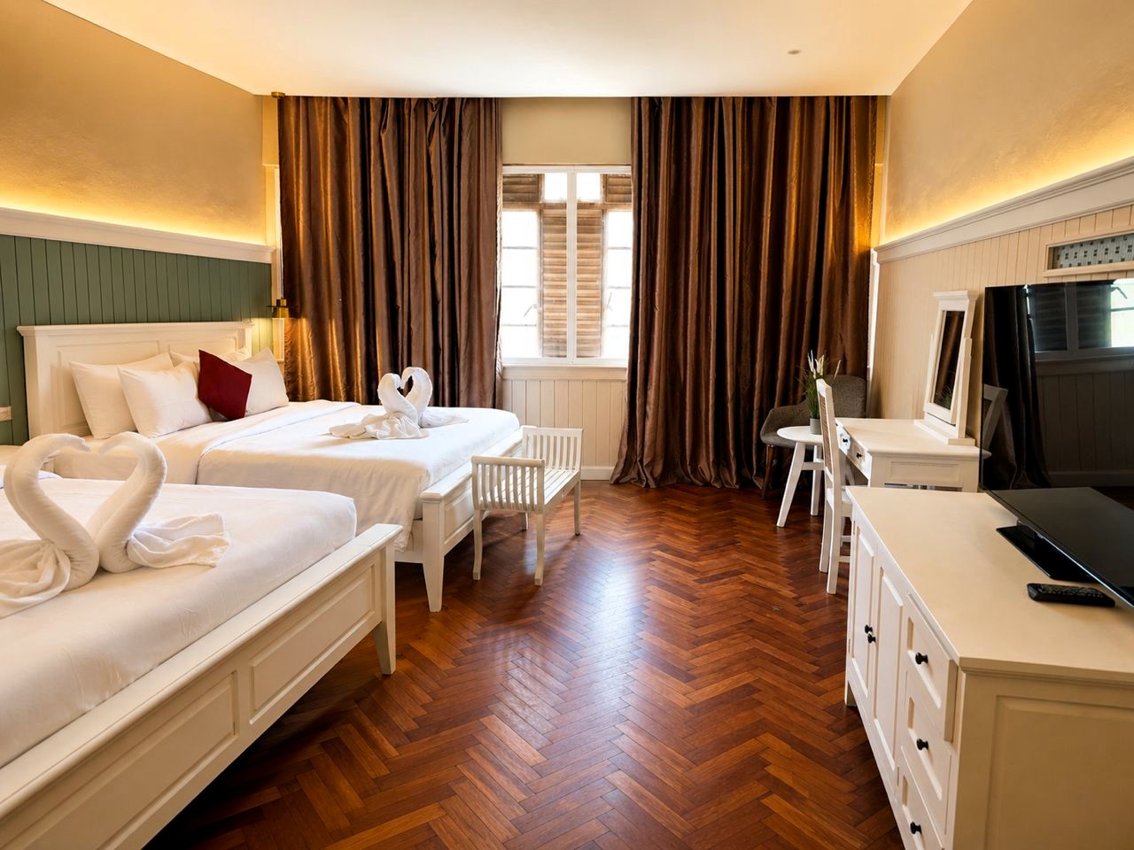 Spacious family room with TV and wood floors at The Chambers Hotel Penang